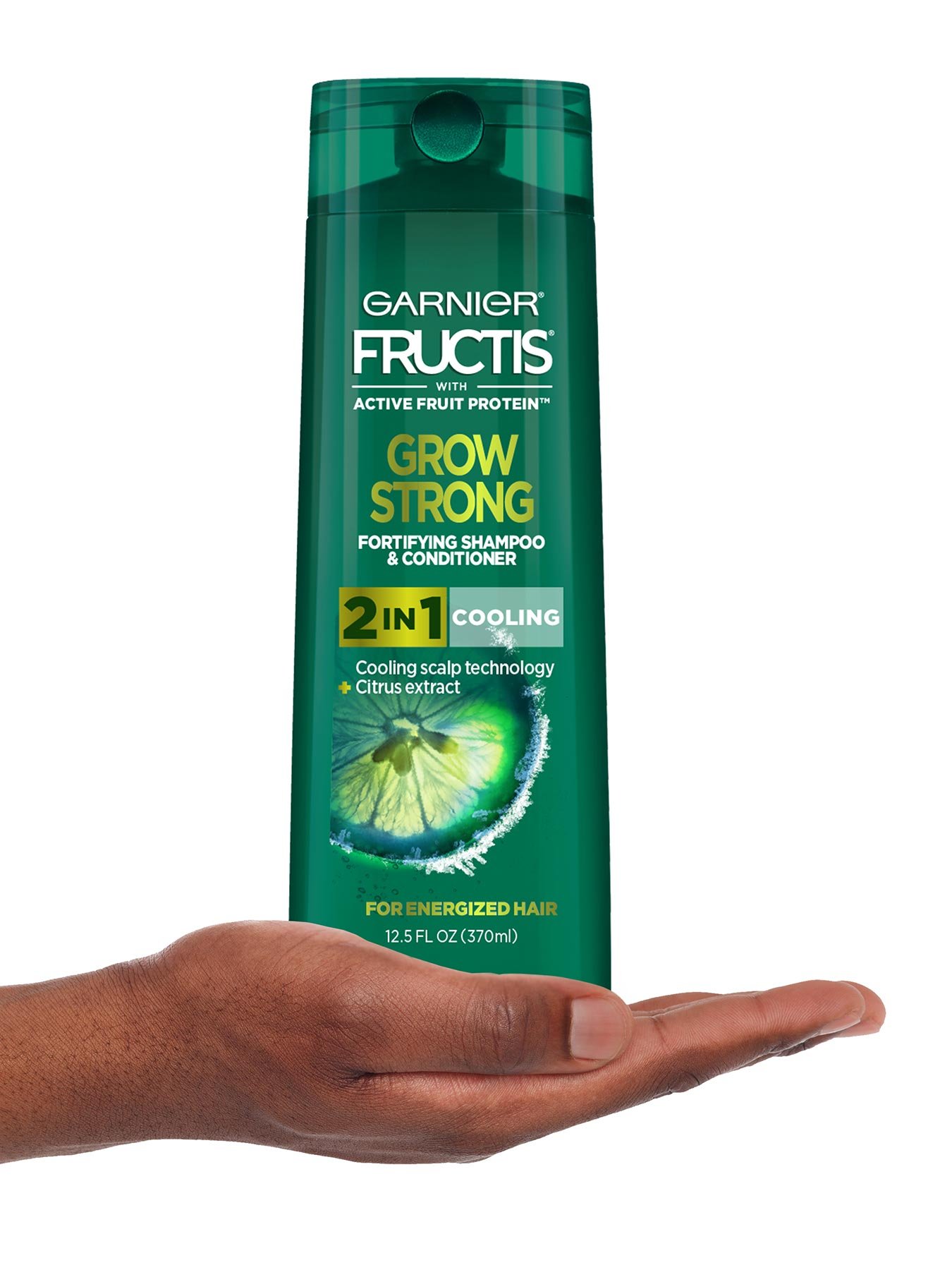 Hand holding Cooling 2-In-1 Shampoo and Conditioner for Men.